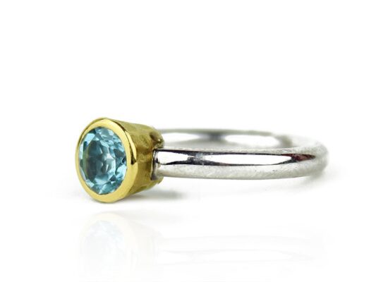 Silver and yellow gold ring with blue topaz.