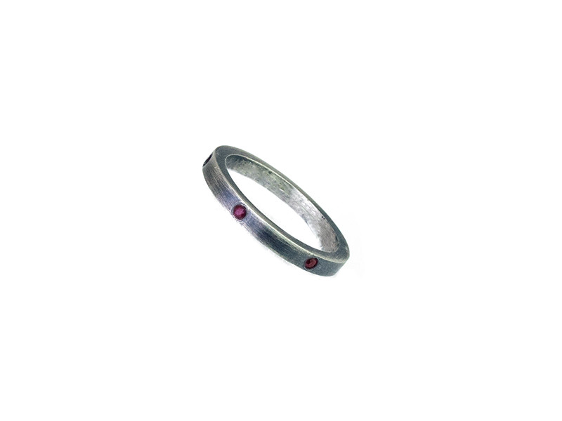 Satin silver wedding band with 8 natural rubies. Satin silver wedding band with 8 natural rubies.