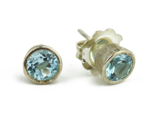 Silver earrings with blue topaz stone.