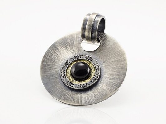 Pendant made of silver, yellow gold, onyx and black diamonds.
