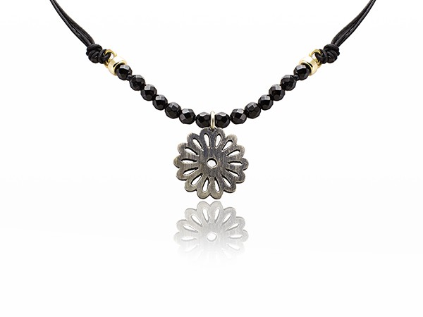 Silk and onyx bead necklace with a silver flower pendant. Silk and onyx bead necklace with a silver flower pendant.