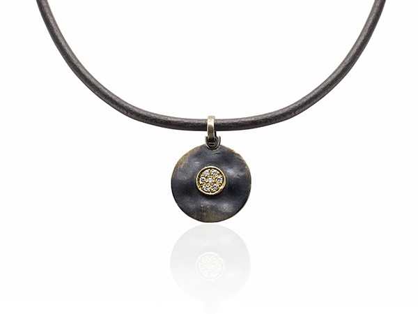 Silver and yellow gold pendant with white diamonds. Leather not included. Silver and yellow gold pendant with white diamonds. Leather not included.