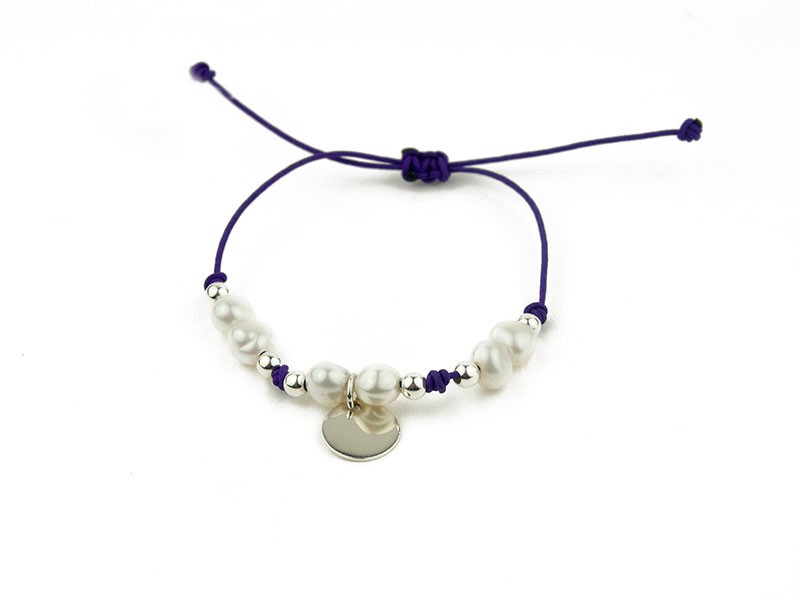 Cord bracelet with pearls, beads and a silver plate. Cord bracelet with pearls, beads and a silver plate.