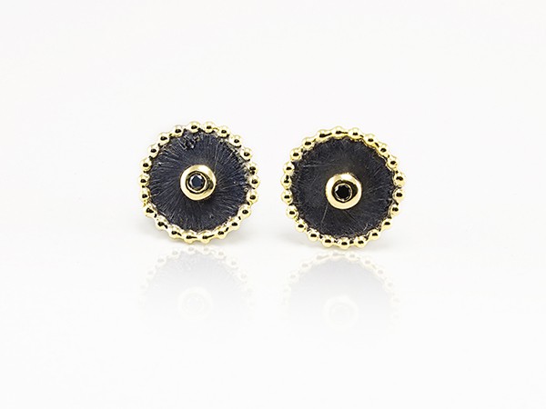 Silver and yellow gold earrings with black diamonds. Silver and yellow gold earrings with black diamonds.