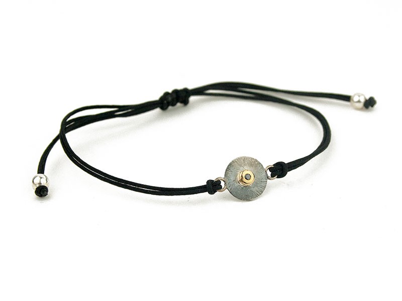 Silk cord bracelet with silver plate, gold opening and black glitter. Silk cord bracelet with silver plate, gold opening and black glitter.
